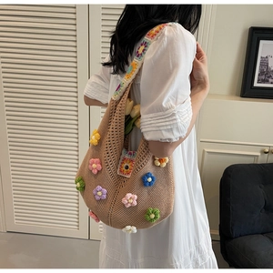 Detail view of khaki crochet hobo bag with colorful handmade 3D floral accents