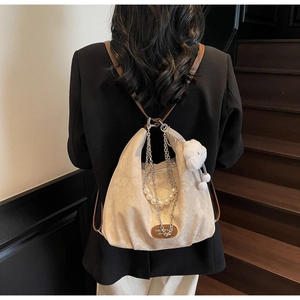 Detail of off-white hobo bag with pearl chain, leather strap and plush bear charm