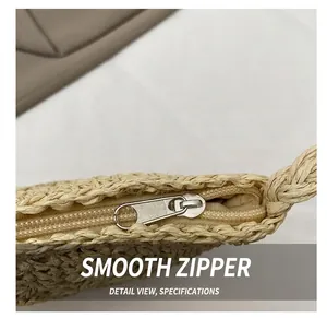 Macro detail of the smooth silver zipper and thick woven texture on straw crossbody bag