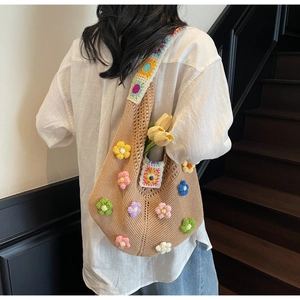 Detail of bohemian crochet shoulder bag with colorful floral patterns and rainbow straps