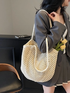 Cream handmade crochet tote bag with hollow diamond pattern for beach and vacation