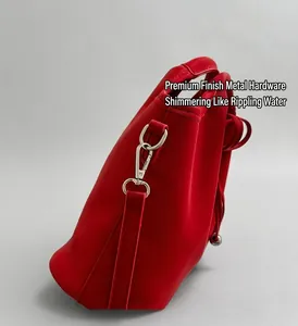 Detailed macro view of vibrant red soft leather bucket bag with silver metal hooks and strap