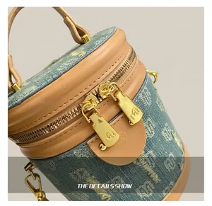 Detail of the golden dual metal zippers on vintage denim jacquard bucket bag