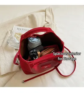 Internal view of a red bucket bag showing large capacity for umbrella and essentials