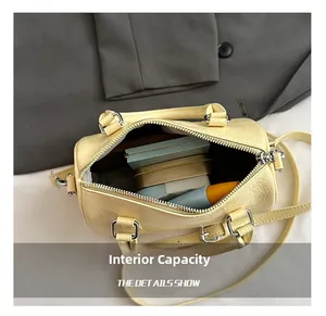 Internal capacity of the yellow Boston bag showing lining and storage for small items