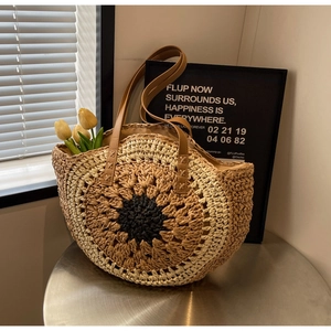 Detail of sunflower handmade woven paper rope straw bag with leather straps and colorful pattern