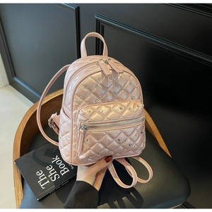 Detailed view of pink quilted mini backpack with sparkling rhinestones and adjustable straps