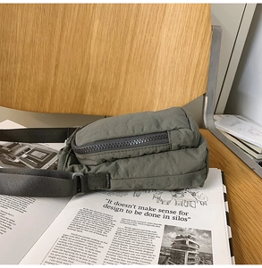 Detail of army green water bottle crossbody bag with waterproof nylon on magazine