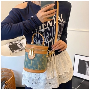Detail of vintage green denim bucket bag with heart jacquard and leather shoulder strap