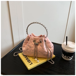 Pink quilted bucket bag with diamond finish, rhinestone handle and pearl chain details