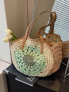 Handwoven straw tote with crochet floral pattern and brown leather straps for beach