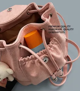 Detail of pink drawstring backpack with silver hardware and soft faux leather texture