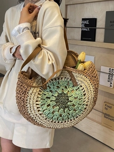 Handcrafted round straw tote with multicolored geometric crochet pattern and leather straps