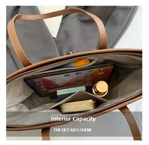 Macro view of brown leather tote bag internal capacity with organized storage compartments