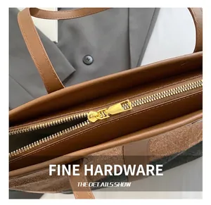 Close-up of premium gold zipper and dual-tone stitching on casual denim tote bag