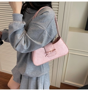 Macro shot of pink wrinkled leather texture and decorative bow on y2k style shoulder bag