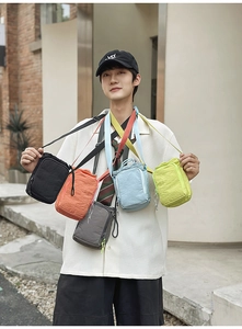 Outdoor male model showcasing multi-color nylon crossbody bags for water bottles and phones