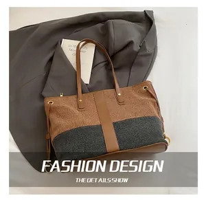 Detail of a large tote bag featuring brown fabric, grey textile, and gold metal ring buckle