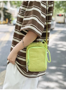 Fluorescent green nylon crossbody water bottle bag with drawstring closure and zip pocket
