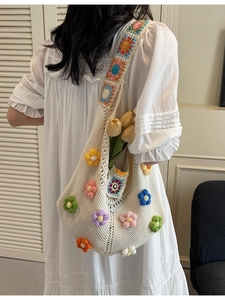 Handmade crochet shoulder bag with colorful 3D flowers and ethnic knit strap