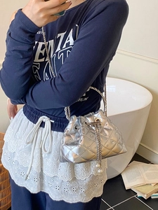 Silver metallic quilted bucket bag with chain strap and pearl charm for women