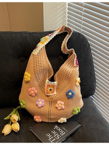 Bohemian crochet hobo bag with 3D floral accents and colorful granny square strap