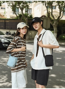 Outdoor shot of compact crossbody bags for water bottles and phones in blue and black colors