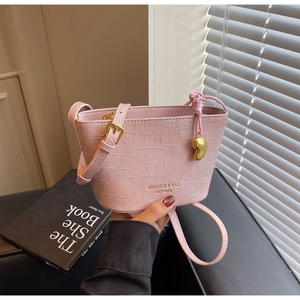 Pink crocodile pattern bucket bag with adjustable strap and heart-shaped metal charm