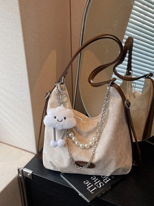 Beige suede hobo bag with brown leather straps and elegant pearl chain detail