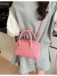 Minimalist pink pebble leather handbag with silver whale charm and shoulder strap