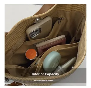 Macro view of woven tote interior with zipper pocket, side slots and magnetic snap