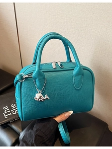 Tiffany blue pebbled leather handbag with silver whale charm and dual zipper design