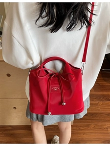 Elegant red leather handbag with ribbon bow decoration for women, casual crossbody style
