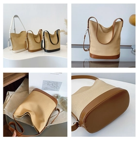 Detail of woven straw bucket bag showing leather base and adjustable metal strap hooks