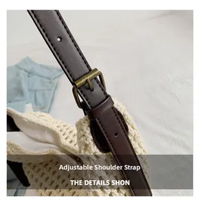 Detail of adjustable dark brown faux leather strap with bronze buckle on woven tote bag