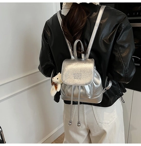 Silver metallic pleated backpack with drawstring and cute white plush bear charm