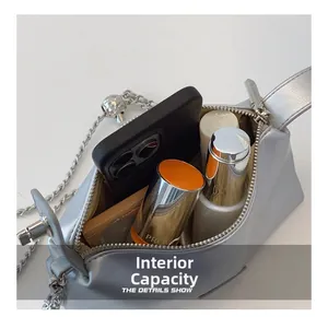 Detailed internal capacity showing silver metallic bag holding phone and cosmetics