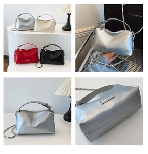 Detail view of four colors of stylish crossbody bags with metal chains and top handles