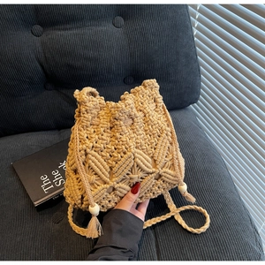 Detailed macro weave pattern and drawstring closure with wooden beads on bucket bag