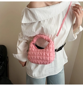 Detail of pink quilted cloud bag featuring soft texture and adjustable shoulder strap