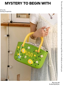 Detail of green mesh shower caddy with yellow handles and decorative DIY charms