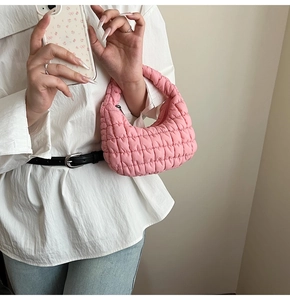Detailed view of pink quilted cloud bag featuring soft puffy texture and zipper closure
