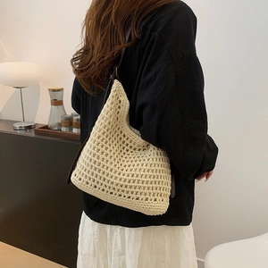 Detailed macro view of handmade woven mesh tote bag with dark brown leather straps