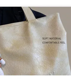 Close-up of the embossed leopard texture and soft PU leather on this beige tote bag