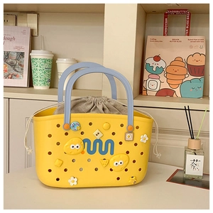 Detail of yellow hollow shower basket with blue handles, grey liner and decorative charms