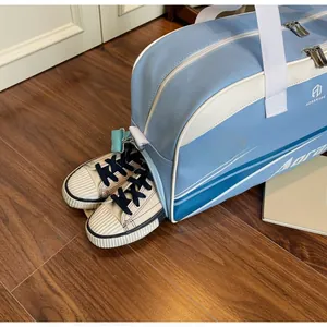 Detail view of the travel fitness bag showing a separate side compartment for shoes