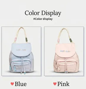 Detail view of pink and blue nylon backpacks with drawstring closures and bead tassels