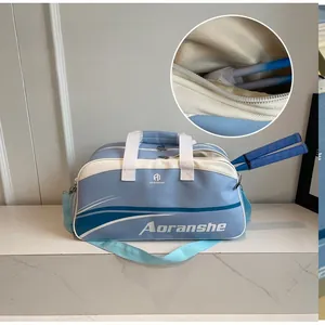 Detail showing the specialized side racket pocket of this blue and white sports bag