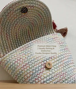 Detail of woven bucket bag featuring rainbow wave stitching and golden magnetic snap closure