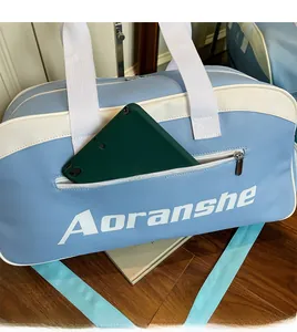 Close-up of front zipper pocket on sports bag showing tablet storage capacity